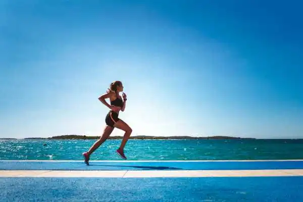 Woman running showing strong leg muscle Edinburgh
